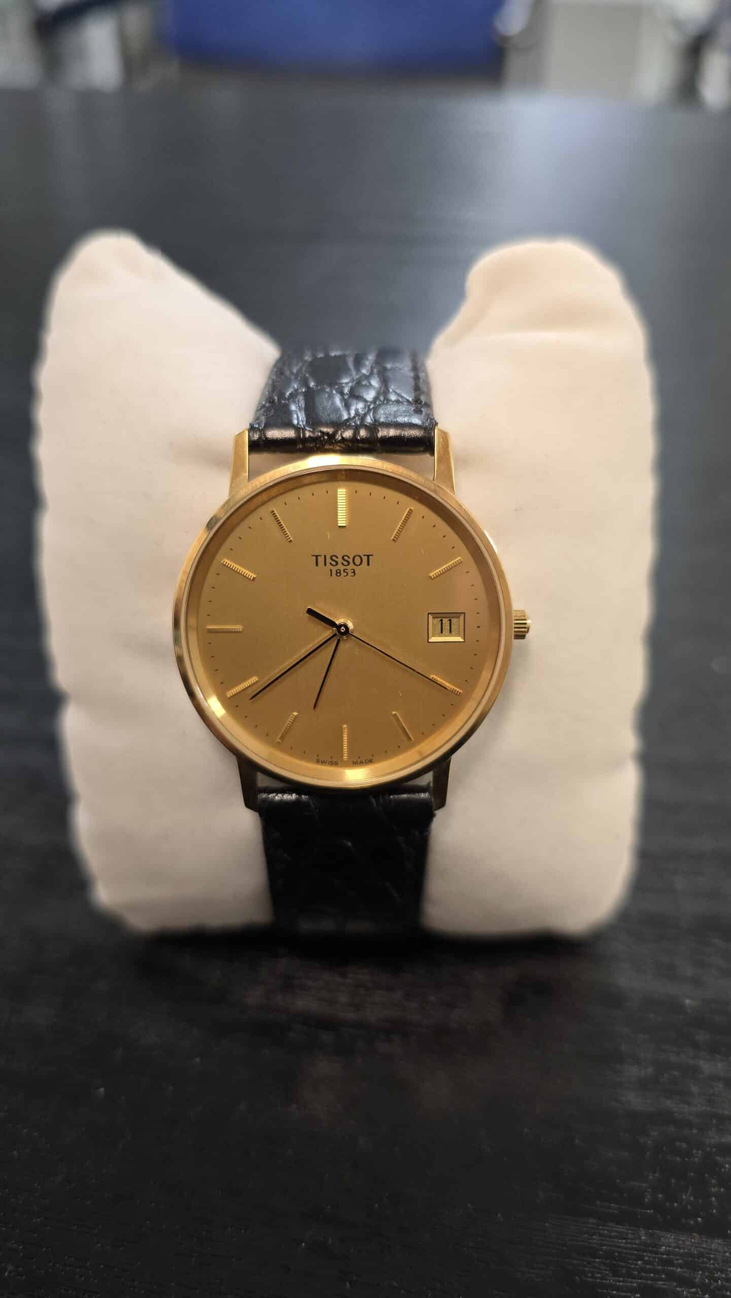 Tissot 1853 Gold Certificate 14K miesten rannekello kullanvärisellä taululla ja mustalla nahkarannekkeella
